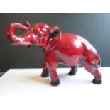 A Royal Doulton Flambé glazed model of an elephant, (19cm x 13cm).