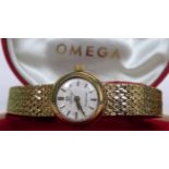 A lady's 9 carat gold cased Omega Ladymatic wristwatch to a 9 carat gold snake link bracelet,