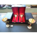 A set of four Stuart Devlin silver and gilt goblets, each in presentation box, (15cm),