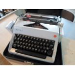 A cased Olympia typewriter.