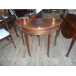 An Edwardian demi-lune mahogany and inlaid fold-over card table, (92cm wide).