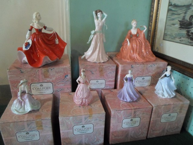 A collection of seven Coalport figurines, each with original box,