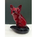 A Royal Doulton Flambé glazed model of a seated fox, (10.8cm).