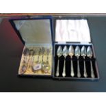 A box set of six Continental silver coffee spoons and sugar nips,