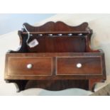 An Edwardian mahogany wall mounted pipe rack, having twin inlaid drawers, (28cm wide).