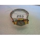 A lady's 9 carat gold cased wristwatch, the circular enamel dial bearing Arabic numerals,
