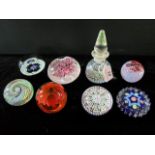 A collection of eight glass paperweights to include examples by Edinburgh and Caithness.