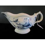 A 19th century Worcester (or Caughley) blue and white sauce boat in the Porter Landscape pattern,