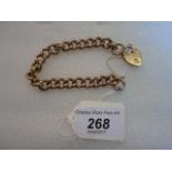 A curb pattern bracelet with padlock clasp, both stamped 9 carat, 14.5 grams.