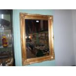 A gilt framed rectangular wall mirror, the bevelled edged glass, (64cm x 42cm).