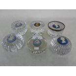 A collection of six Wedgwood glass paperweights, five with applied Jasperware mounts,