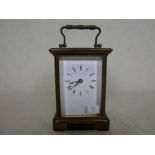 A French gilt brass carriage clock, having five bevelled edge glass panels,