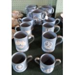 A quantity of blue Wedgwood Jasperware tankards, loving cups and tygs,