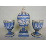 A Wedgwood pale blue Jasperware jar and cover, having allegorical surmount on a square plinth, 22cm,