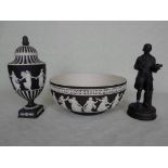 A large Wedgwood Jasperware fruit bowl on black ground, typically decorated with dancing maidens,