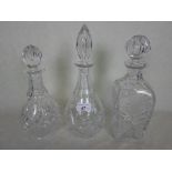 Three cut glass decanters of various shapes, the tallest 32cm.