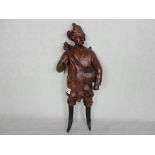 An unusual wall mounted hardwood carved figure of a hunter, possibly Black Forest, 43cm.