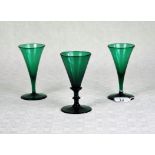 A Bristol green wine glass of conical form on stepped column, (13cm),