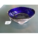 An Edwardian oval silver dish with blue glass liner, the frame of pierced foliate form,