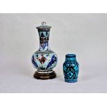 A large 19th century bottle vase and cover, decorated in the Isnik manner,