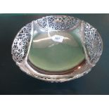 A mid-20th century silver circular bowl, pierced borders on four supports, Sheffield hallmarks,