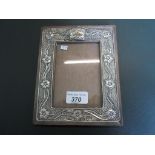 A wooden rectangular silver mounted photo frame, Birmingham hallmarks 1904, (19cm x 15cm).