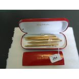 A collection of four gold plated and gilt metal Sheaffer ball point pens.