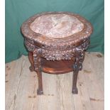 A Chinese heavily carved hardwood and marble topped two tier circular table, 52cm diameter,