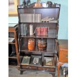 A reproduction waterfall bookcase, having twin lower drawers, 77cm wide.