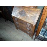 A carved oak three drawer bureau, 74cm wide.