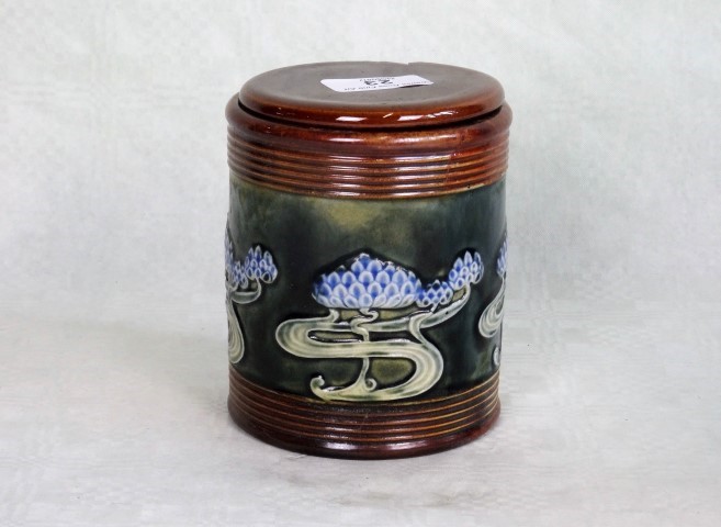 An early 20th century Royal Doulton stoneware tobacco jar and associated cover,
