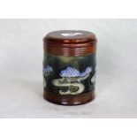 An early 20th century Royal Doulton stoneware tobacco jar and associated cover,