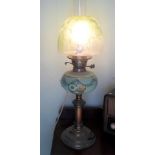 A Victorian green glass and brass oil lamp, later converted to electricity,