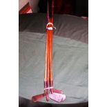 A collection of five golf clubs, 20th century, each with wooden shafts,