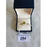 A 9ct yellow gold peridot and diamond ring.