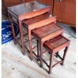 A set of four Chinese-style hardwood nesting tables, having inlaid silvered decoration of horses,