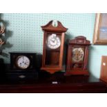 A Victorian slate mantle clock, the circular enamel dial bearing Roman numerals,