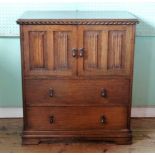 An early 20th century oak cupboard, having twin linen fold doors over two drawers, 81cm wide.