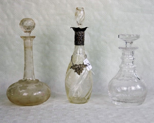 Three decanters of varying form, 19th century and later, one having a silver collar,