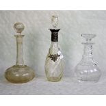 Three decanters of varying form, 19th century and later, one having a silver collar,