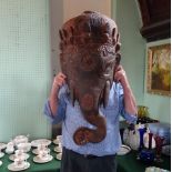 A late 19th/early 20th century Nepalese hardwood carved Ganesh head, 83cm.