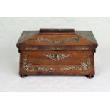 A rosewood and mother of pearl inlaid tea caddy of sarcophagus form,