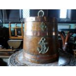 An oak, copper and brass mounted coal bin of barrel form, 28cm diameter.