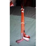 A collection of five golf clubs, early 20th century, each with wooden shafts,