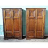 A pair of early 20th century carved oak two door wardrobes, each 105 x 168 x 48cm.