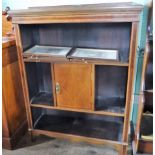 An Edwardian mahogany and inlaid bookcase, having central cupboard door on plain supports,