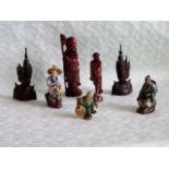 Seven Oriental figurines, to include carved wood and ceramic examples, the tallest 20cm.