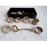 A mixed lot to include: a group of silver napkin rings, mother of pearl handled fruit knives,