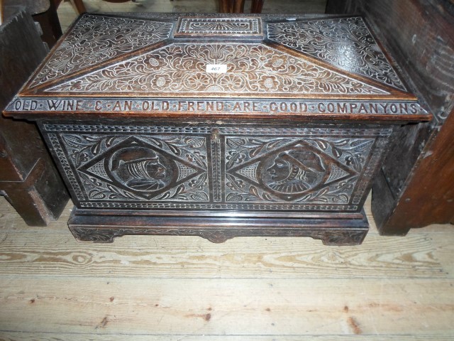 A 19th century and later oak carved coffer of sarcophagus form, later converted to a wine cooler,