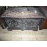 A 19th century and later oak carved coffer of sarcophagus form, later converted to a wine cooler,